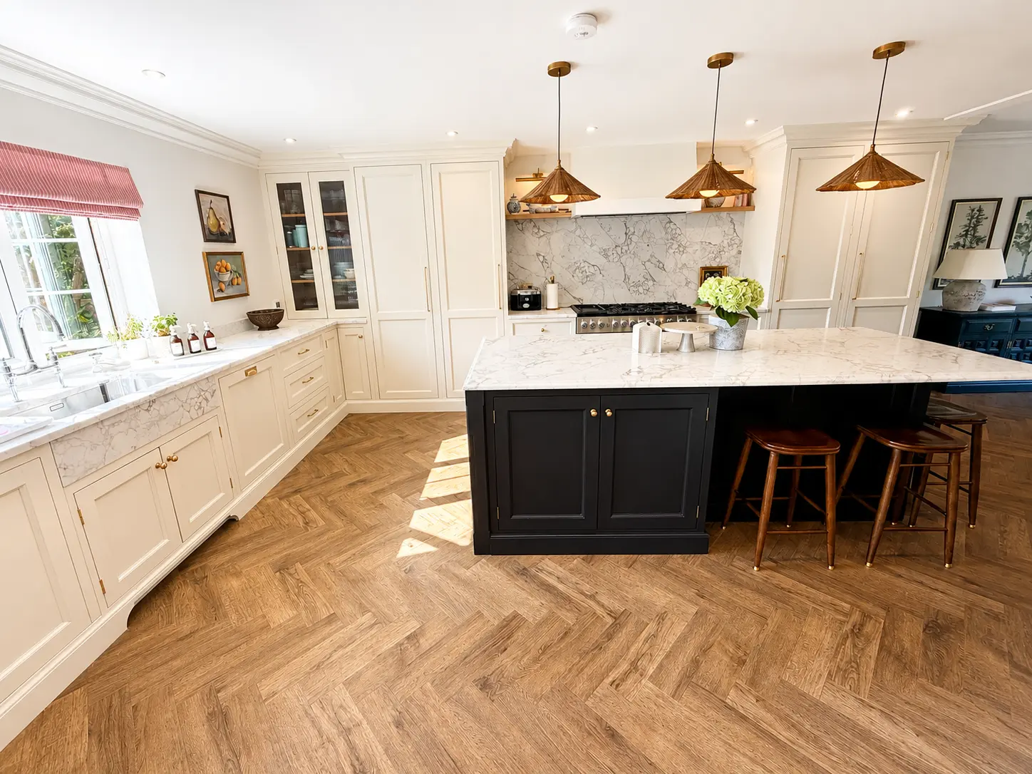 Kitchen with marble island, range cooker and rattan pendants
