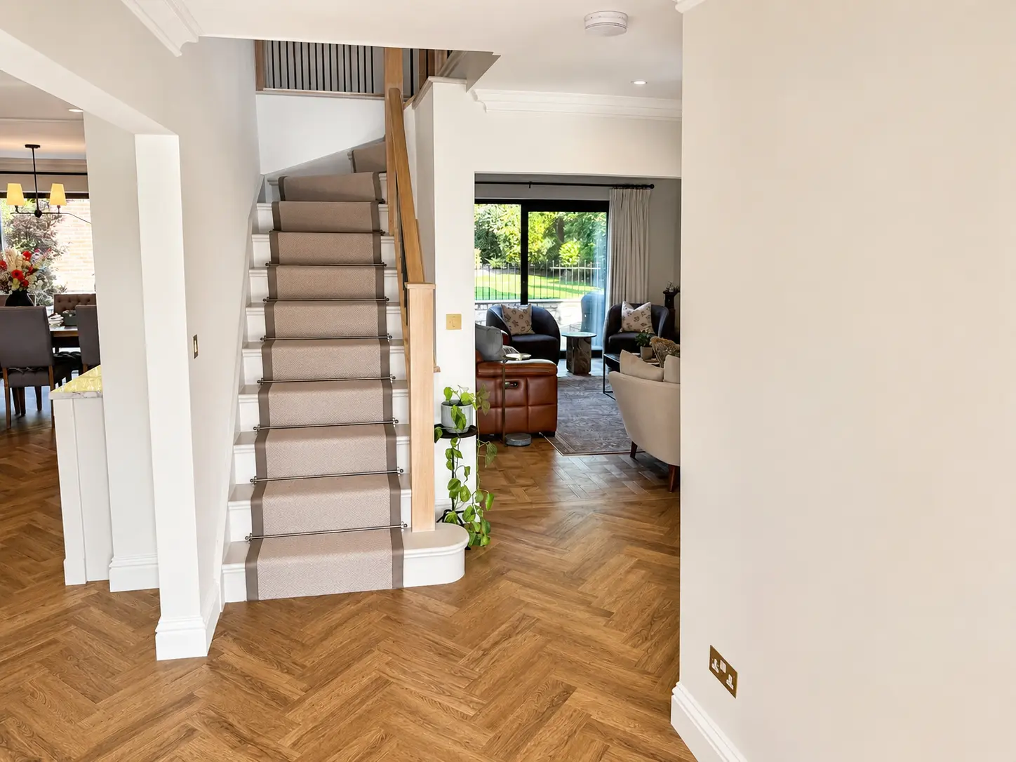 Entrance hall with staircase looking through to the living room and garden