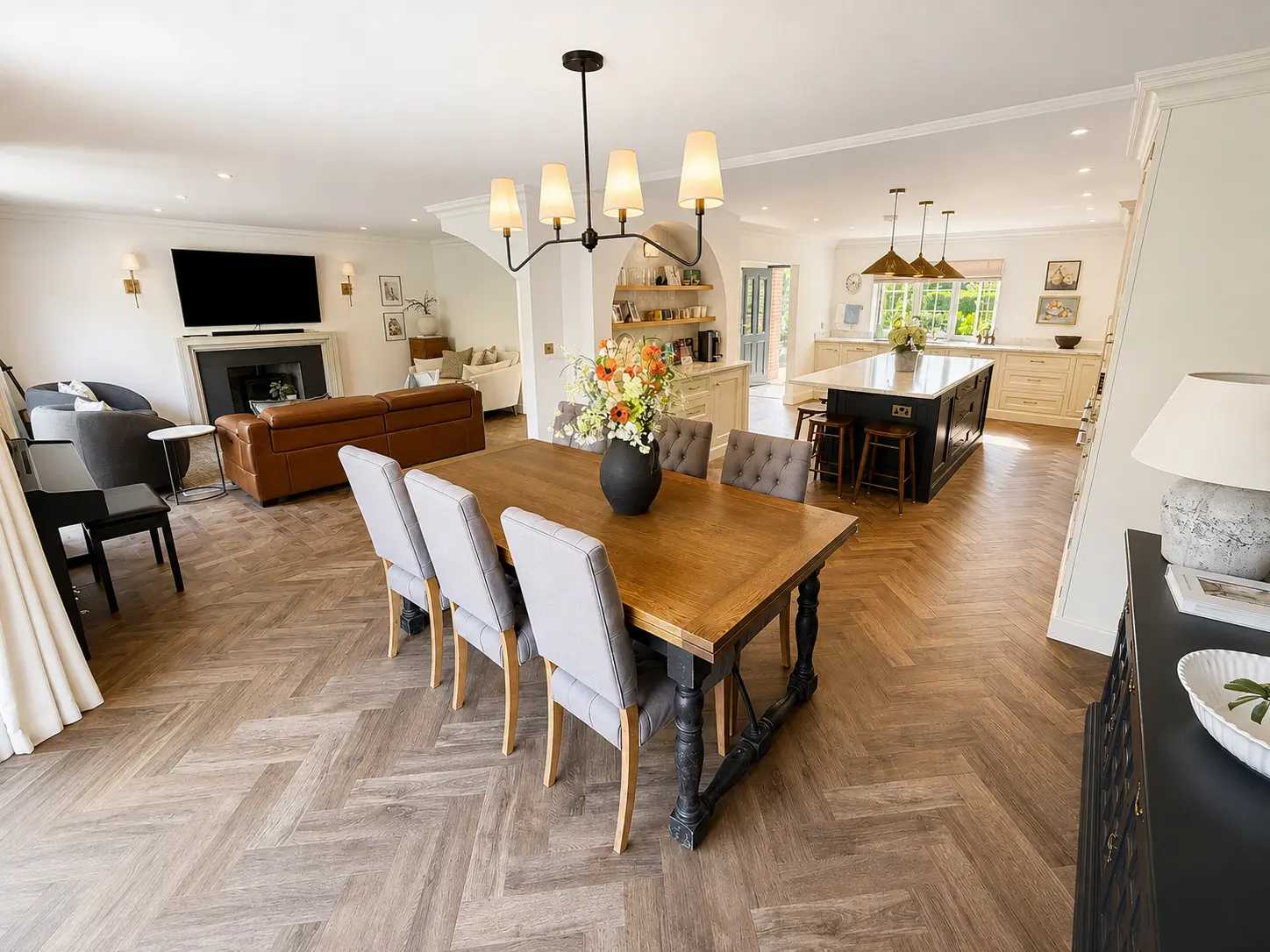 Open-plan kitchen, dining and living space with herringbone floors